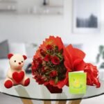 teddy bear and bouquet of red roses