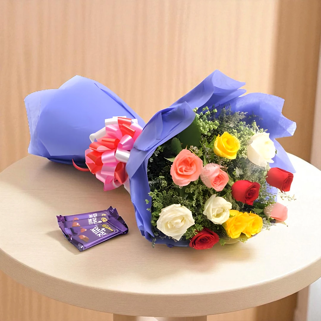 Mixed roses bouquet with Dairy Milk chocolates on table by BetterGiftFlowers Mumbai delivery